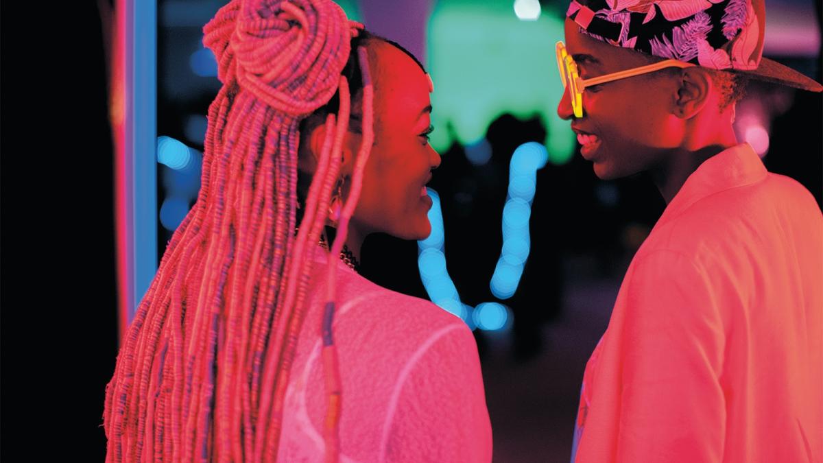 RAFIKI, 2018, two women in neon lit room looking at each other