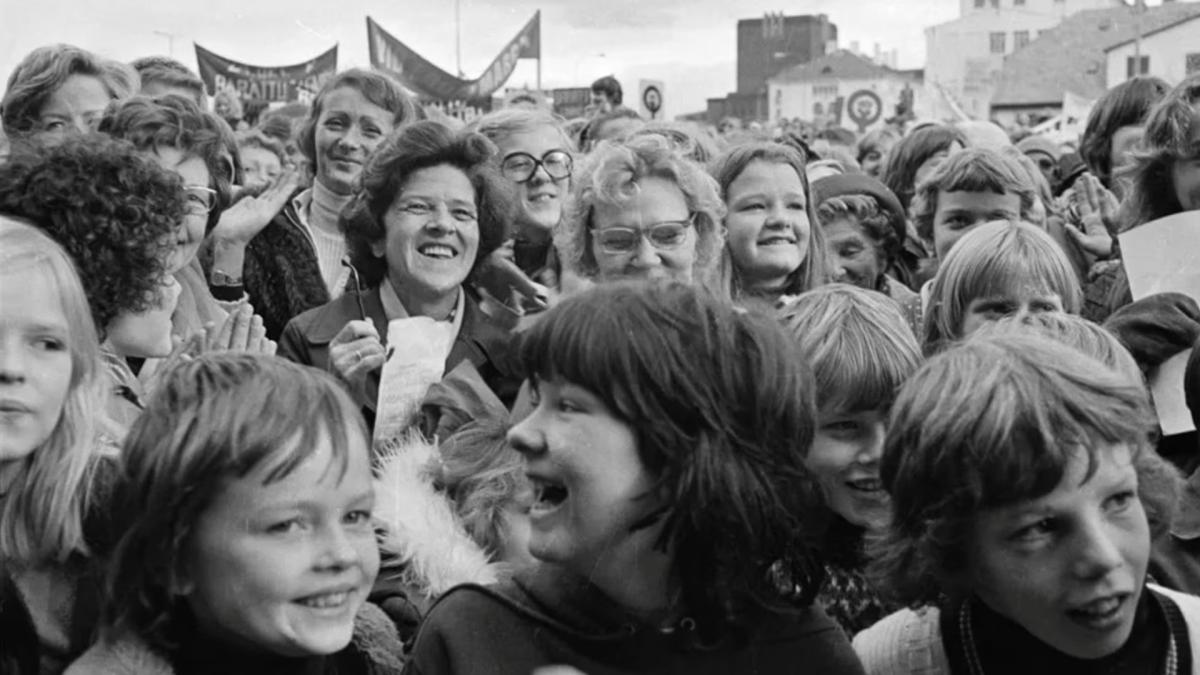 THE DAY ICELAND STOOD STILL, 2024, black and white image of women in street smiling and holding signs