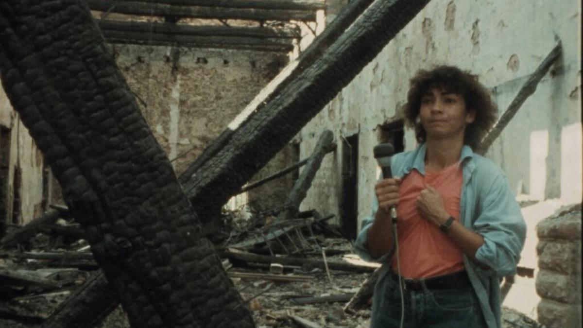 THE BEIRUT TRILOGY, 1976-1982, woman standing holding microphone amidst rubble and dilapidated building