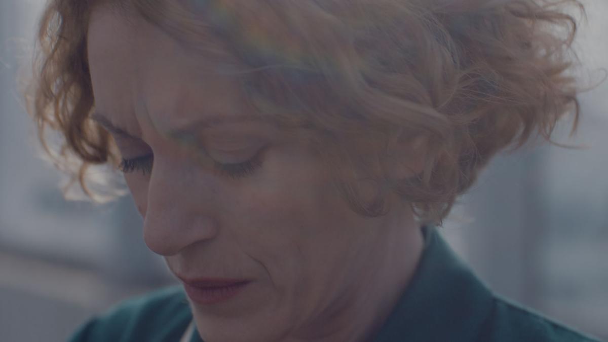 PAUSE, 2018, closeup of woman looking down