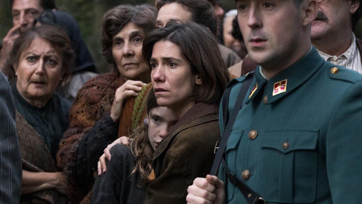 FRONTIER, 2025, group of people huddled together with man in uniform leading them