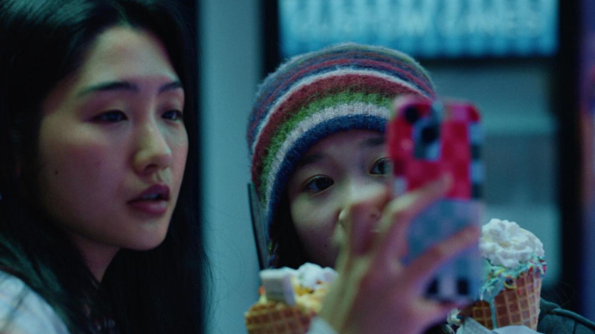 THE OTHER SIDE: AAPI SHORTS, 2025–26, two girls looking at glass window