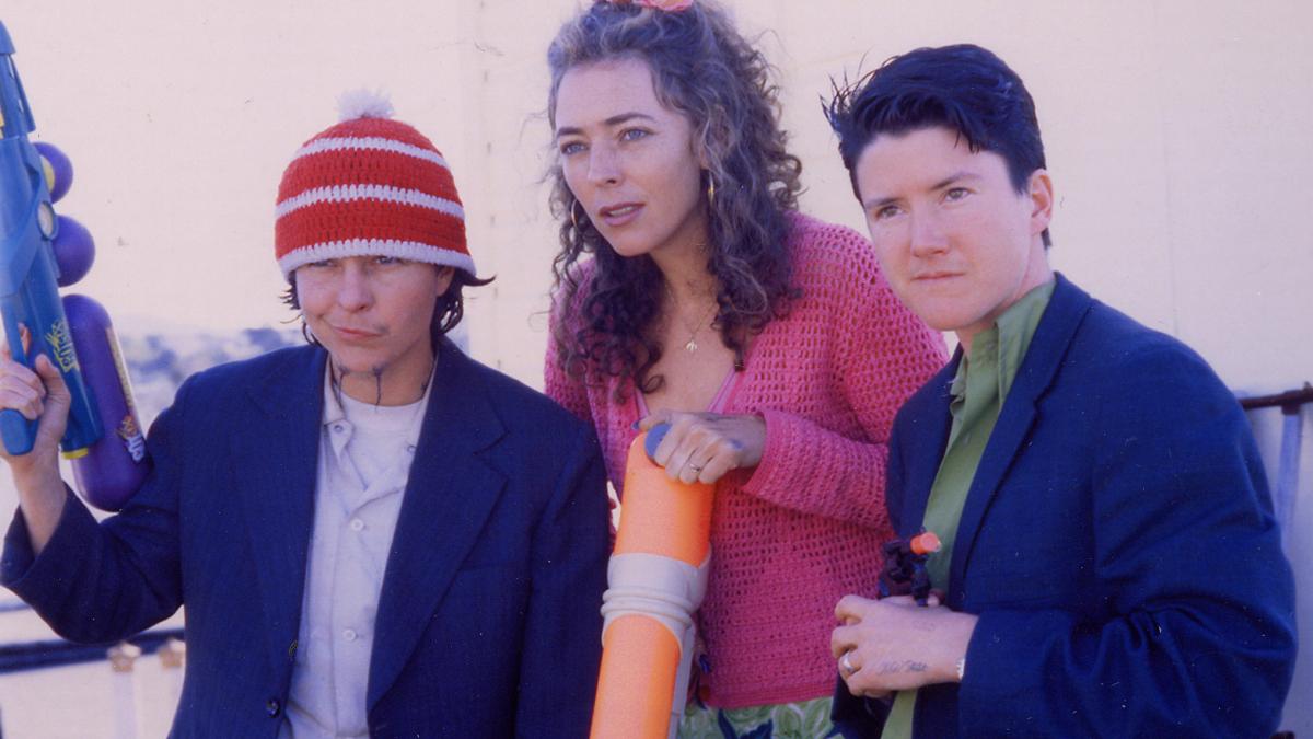 BY HOOK OR BY CROOK, 2001, three young people standing with jackets on looking out into distance