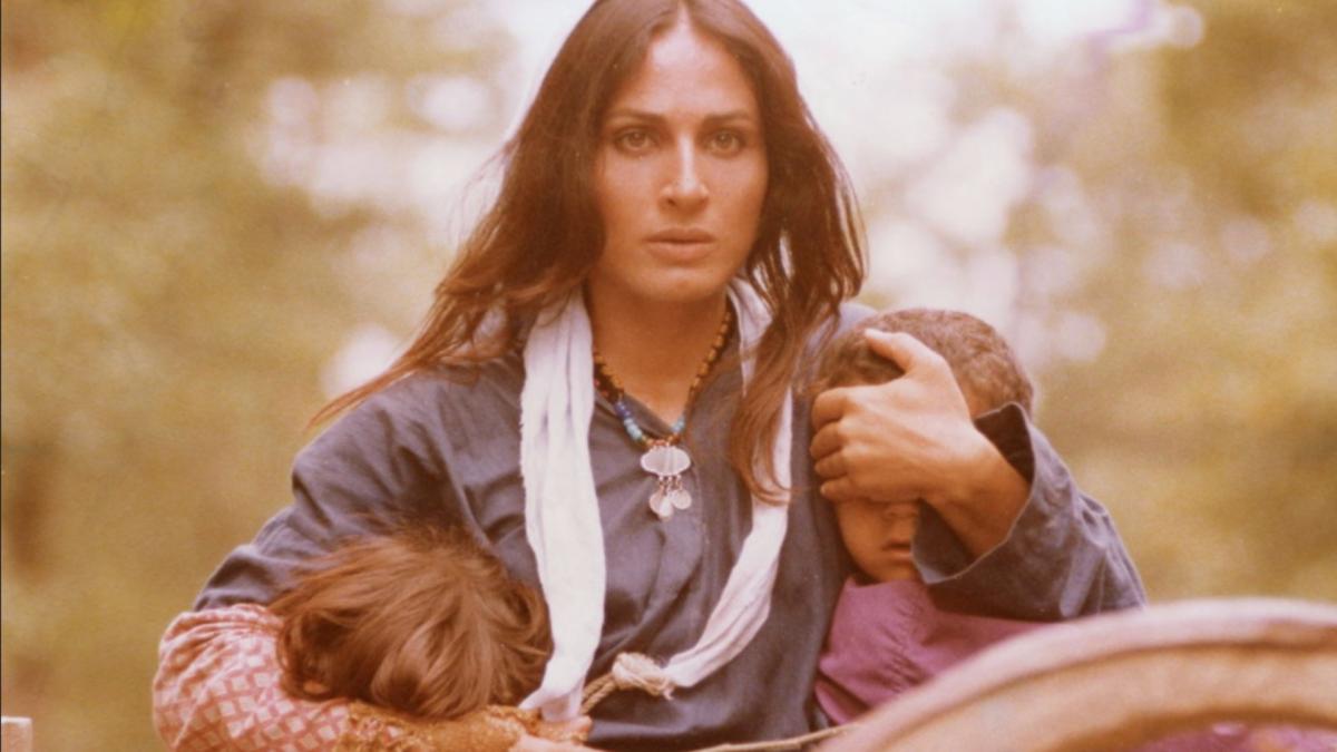 THE BALLAD OF TARA, 1979, woman looking ahead clutching two young children in each arm hiding their faces