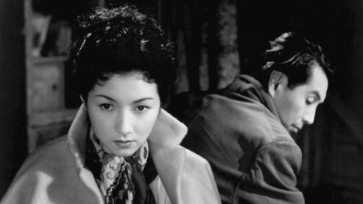 FLOATING CLOUDS, 1955, black and white image of man and woman in jackets with backs turned to each other