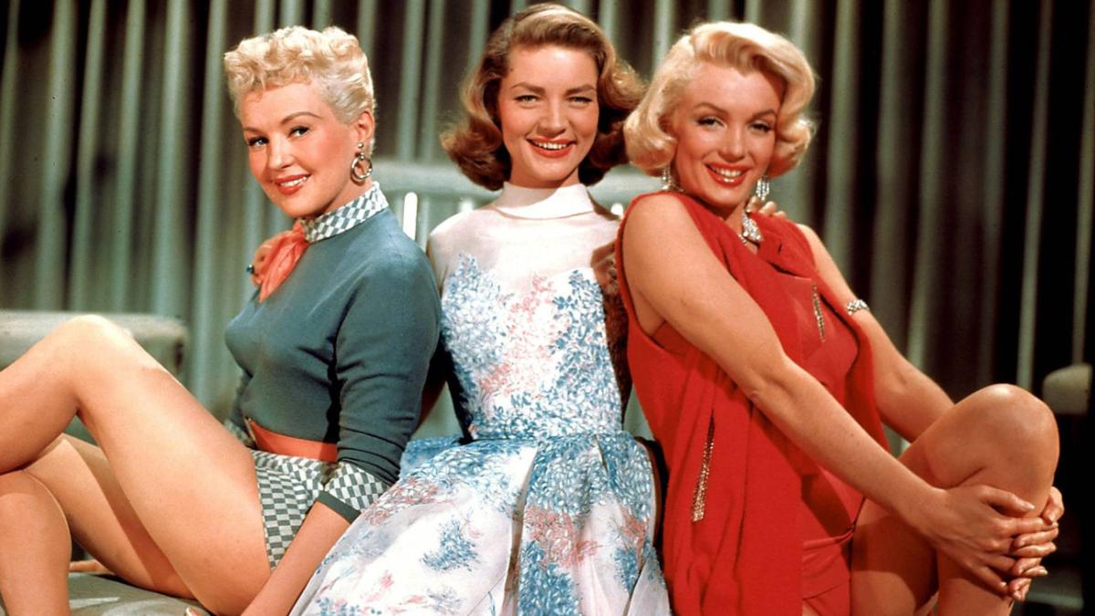 HOW TO MARRY A MILLIONAIRE, 1953, three woman posing on stage 