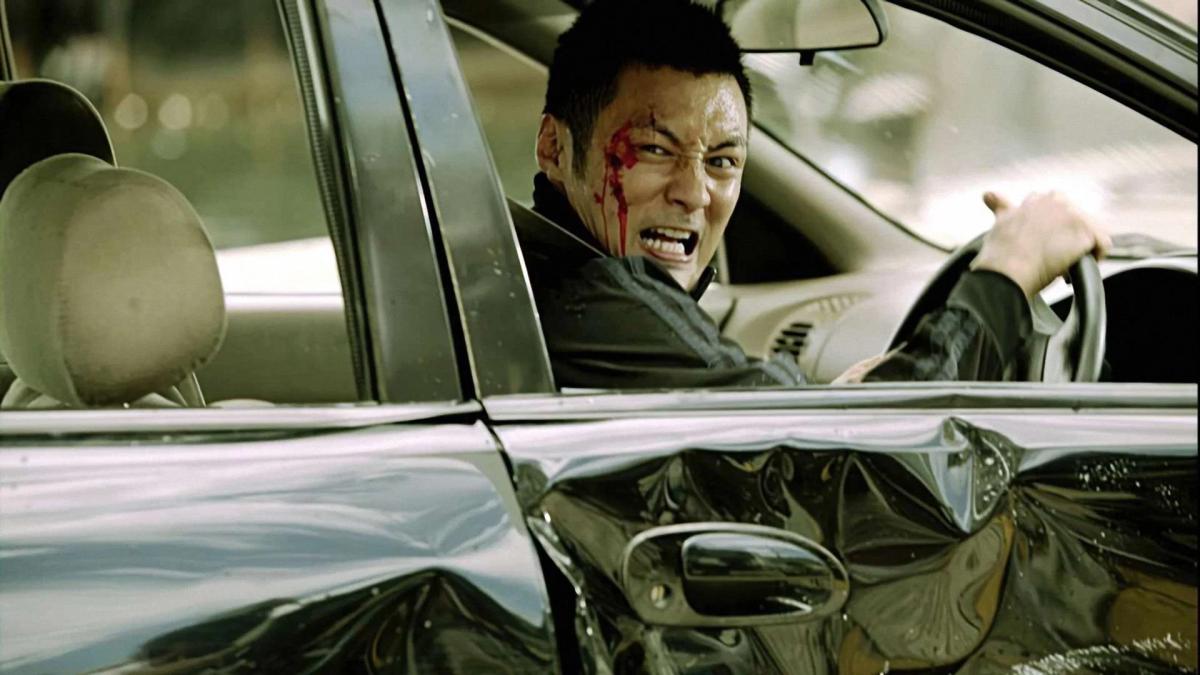 MOTORWAY, 2012, man driving dented car turning around with blood on his forehead