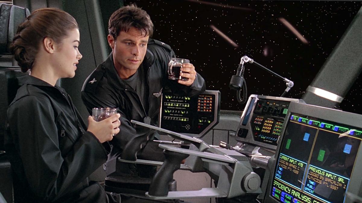STARSHIP TROOPERS, 1997, man and woman in cockpit of spaceship with space in background