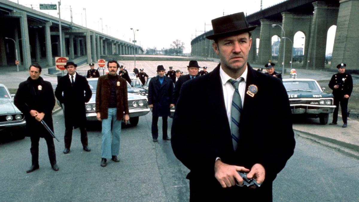 THE FRENCH CONNECTION, 1971, men in suits and hats standing in a formation on street with cars behind them
