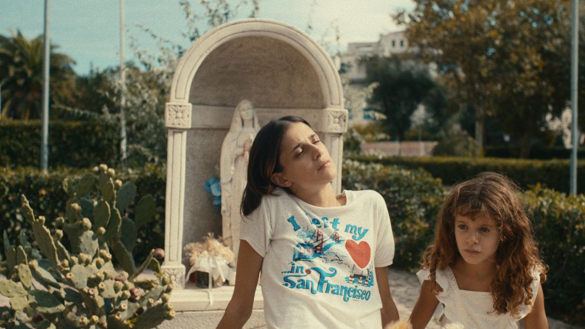THE KIDNAPPING OF ARABELLA, 2025, two girls in white shirts seated comfortably in park garden outside