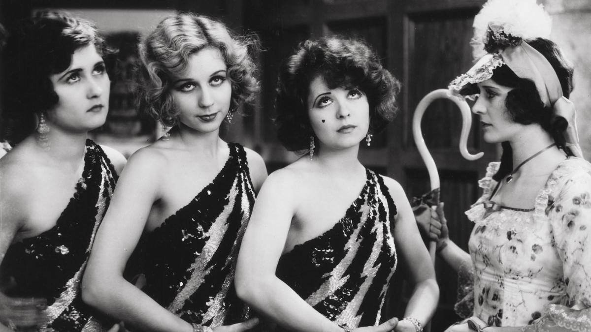 THE WILD PARTY, 1929, black and white image of four girls in dance costumes posing with hands in front of them