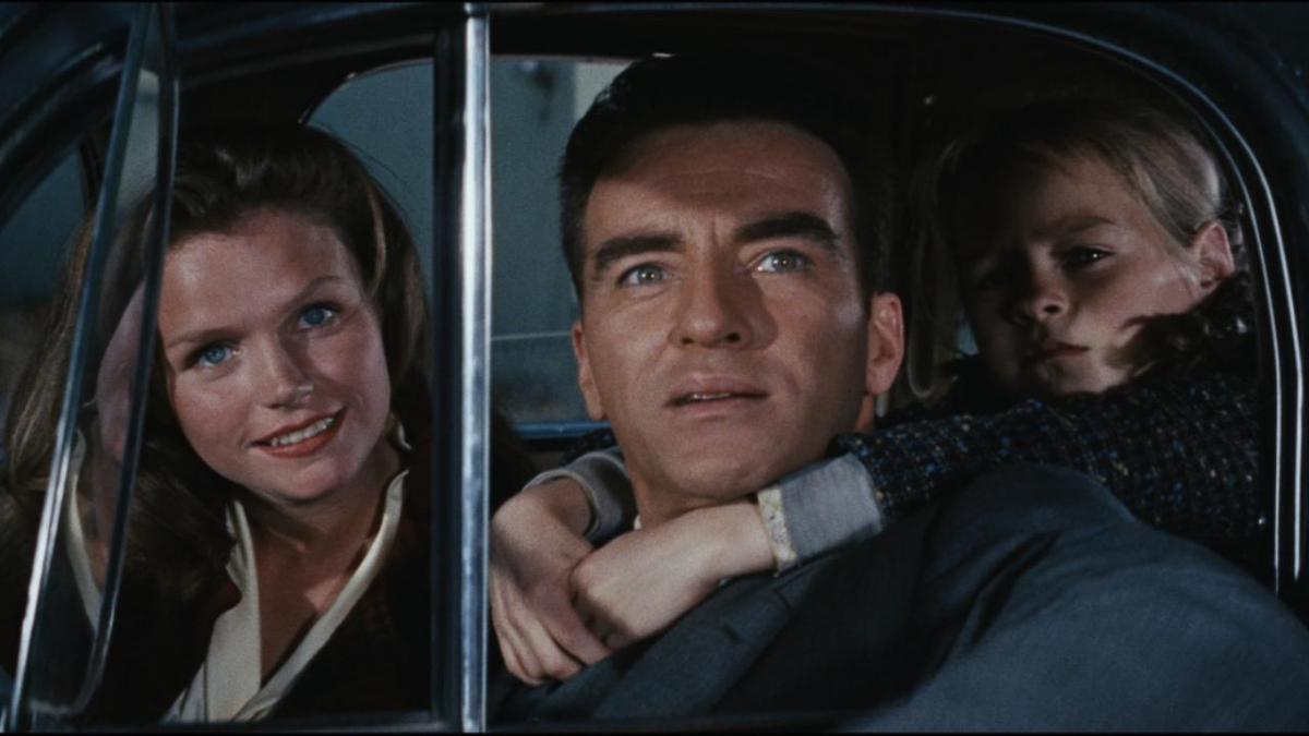 WILD RIVER, 1960, man driving with woman in passenger seat and child with arms around man's neck from backseat looking out window