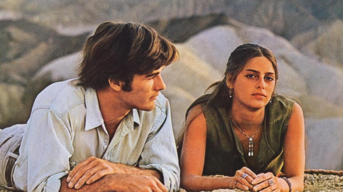 ZABRISKIE POINT, 1970, man and woman lying on stomachs on sandy hill