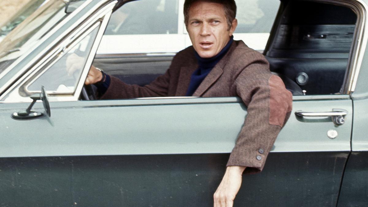 BULLITT, 1968, Steve McQueen driving car with arm leaning out of window