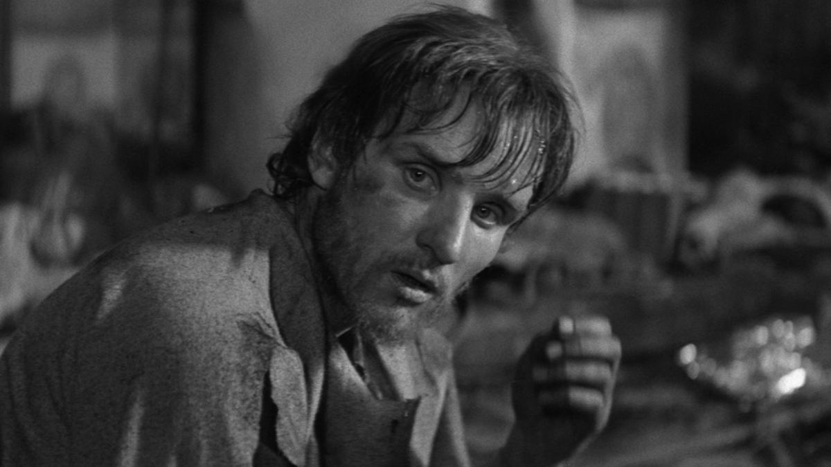 ANDREI RUBLEV, 1966, black and white still of man seated looking off into distance
