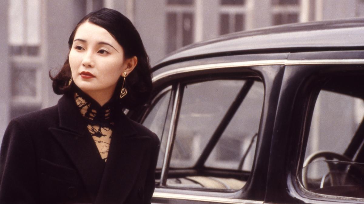 CENTER STAGE, 1991, woman in black coat stepping out of car on street in daylight