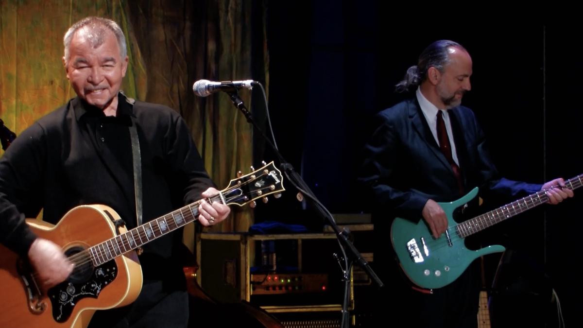 HOW LUCKY CAN ONE MAN GET, 2010, two men playing guitar on stage in black shirts 