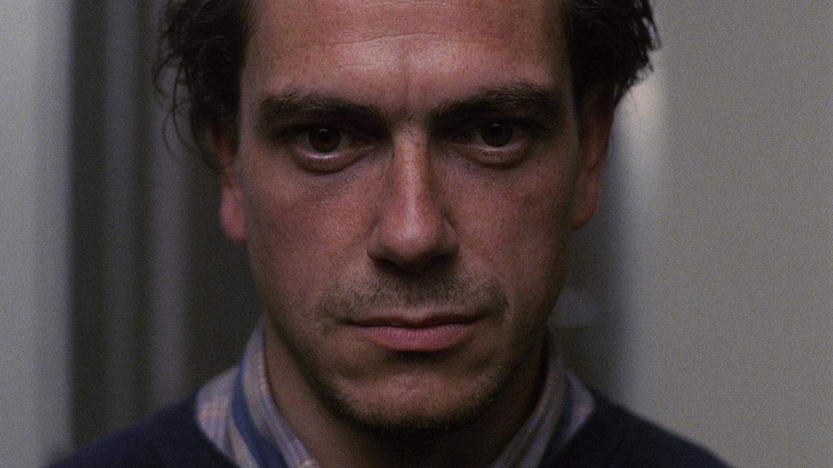 THE VANISHING, 1988, up-close of man's face looking intently forward 