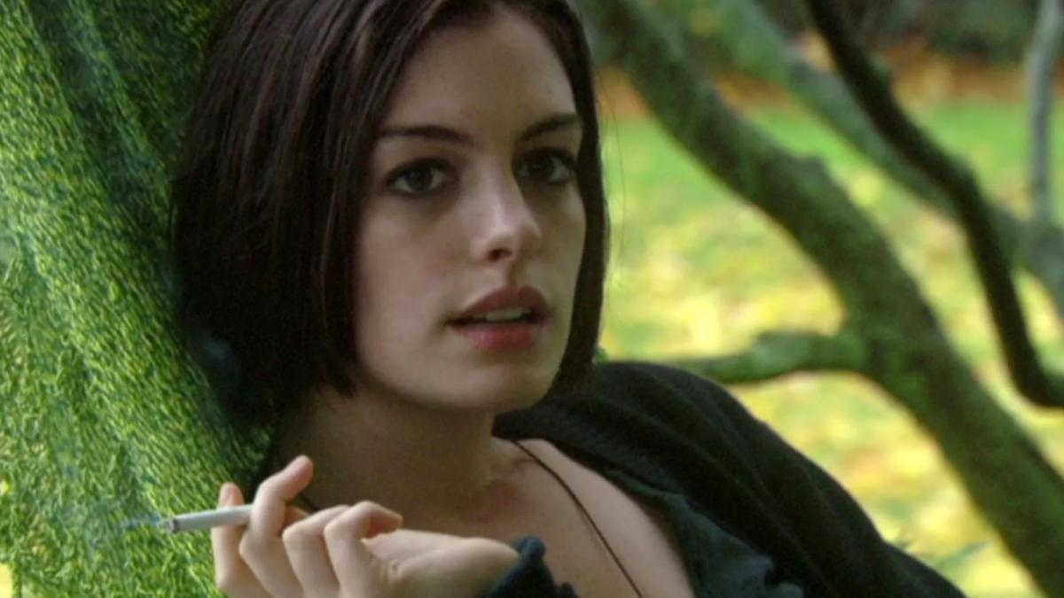RACHEL GETTING MARRIED, 2008, woman with short brown hair wearing sweater and holding a cigarette outside
