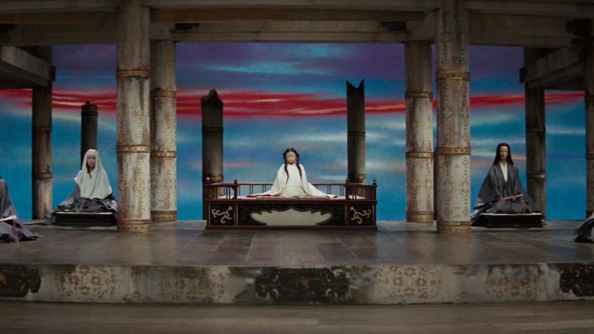 KWAIDAN, 1965, five people wearing Japanese robes seated across raised platform with colorful sunset behind them