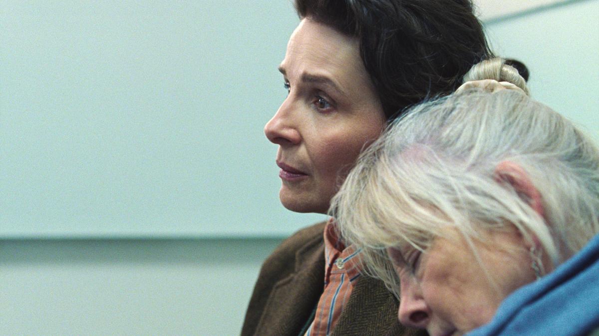 QUEEN AT SEA, 2026, elderly woman with white-gray hair leaning on shoulder of brunette woman
