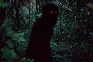 dark person in cloak with red eyes