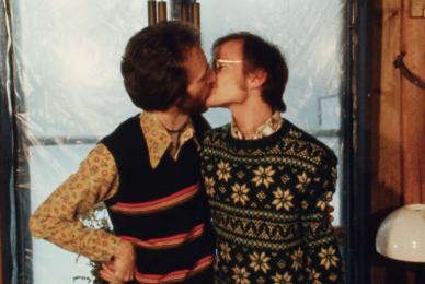 two men in sweaters kissing