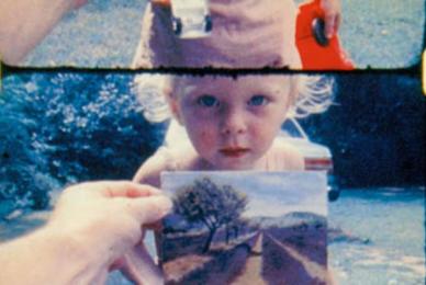 film strips of child in yard looking at camera