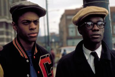 two boys in street clothes wearing hats