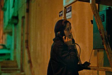 girl in dark alleyway on the phone