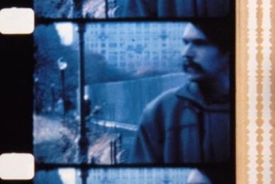 film strip with mustached man looking into distance
