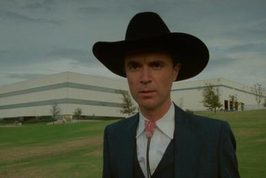 man standing outside with cowboy hat and bolo tie