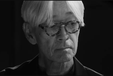 close up of Asian man with gray hair wearing glasses