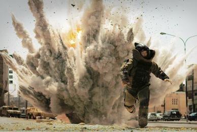 man in battle running from explosion