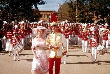 couple walking in parade in the street 